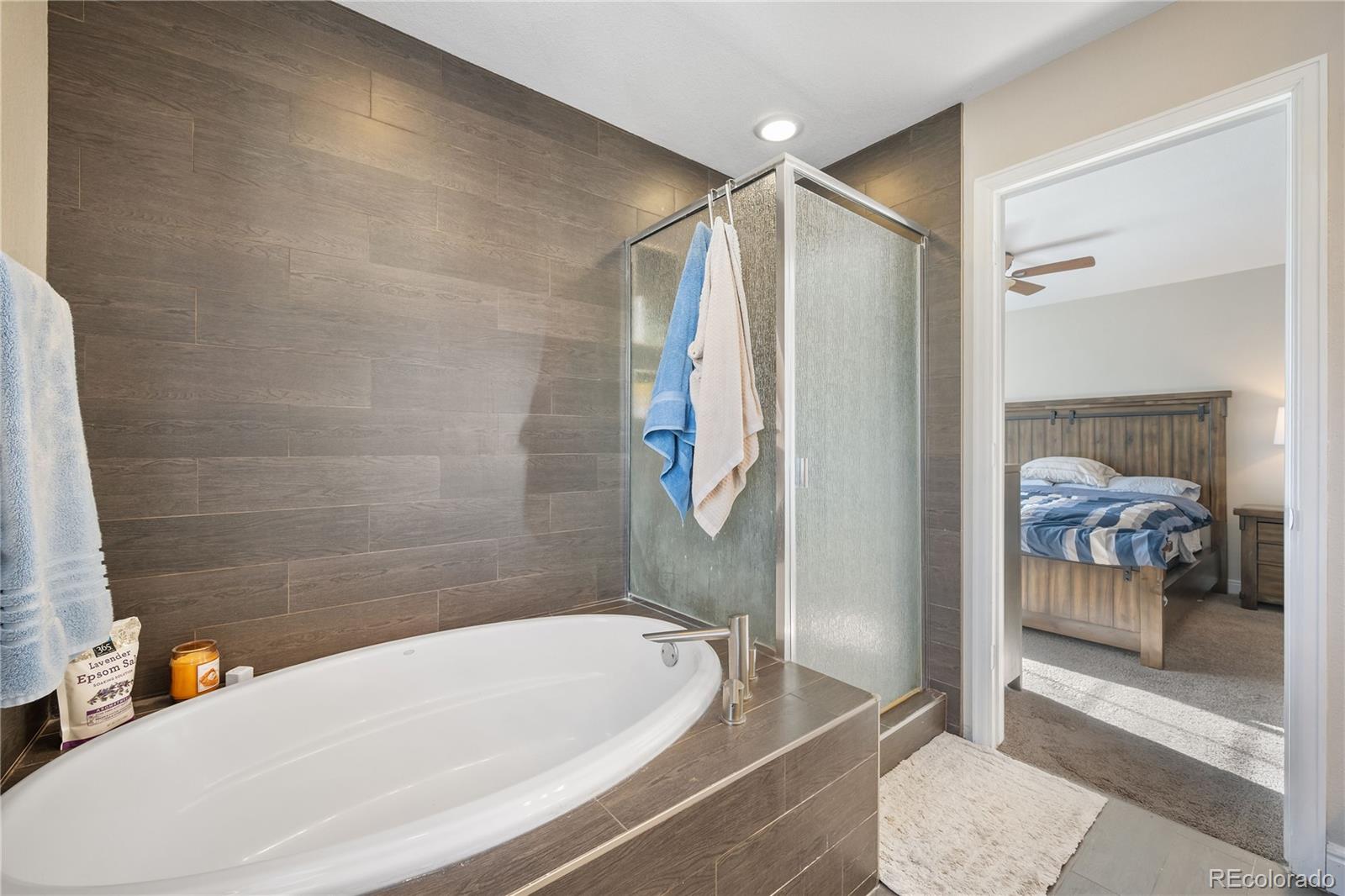 1201 Riddlewood Road Highlands Ranch, CO 80129 - Photo 24 of 36 a bathroom with a tub and a shower