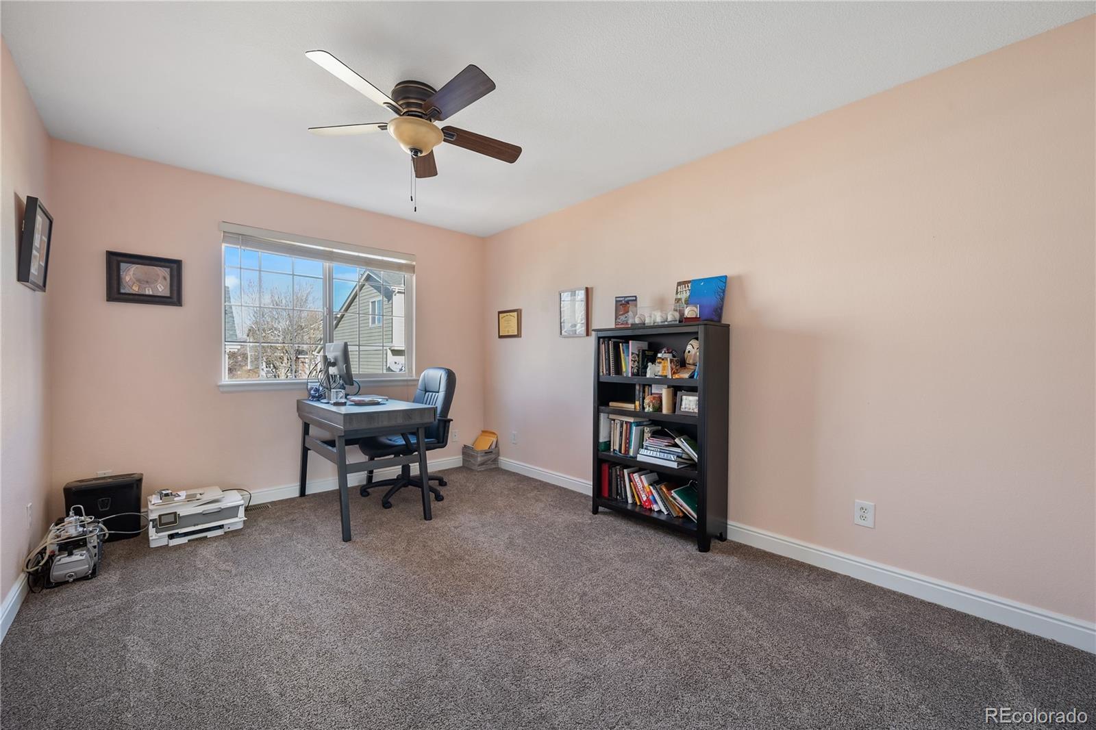 1201 Riddlewood Road Highlands Ranch, CO 80129 - Photo 25 of 36 a view of a livingroom with workspace and a ceiling fan
