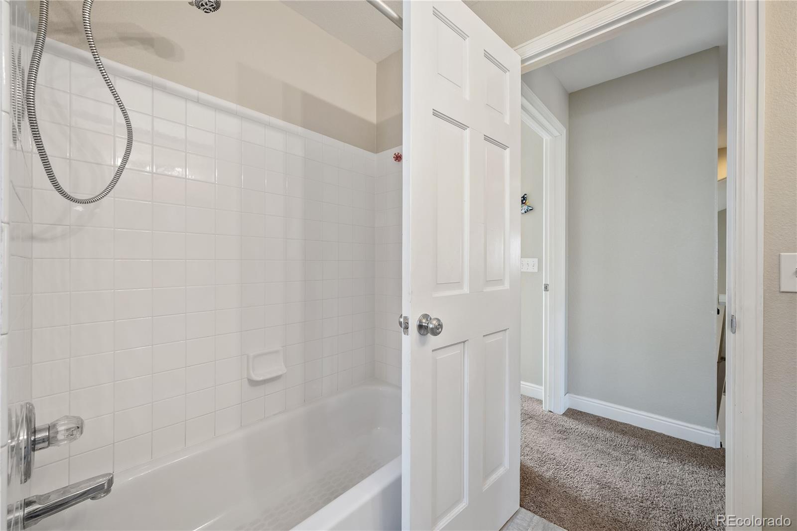 1201 Riddlewood Road Highlands Ranch, CO 80129 - Photo 29 of 36 a bathroom with a glass shower door
