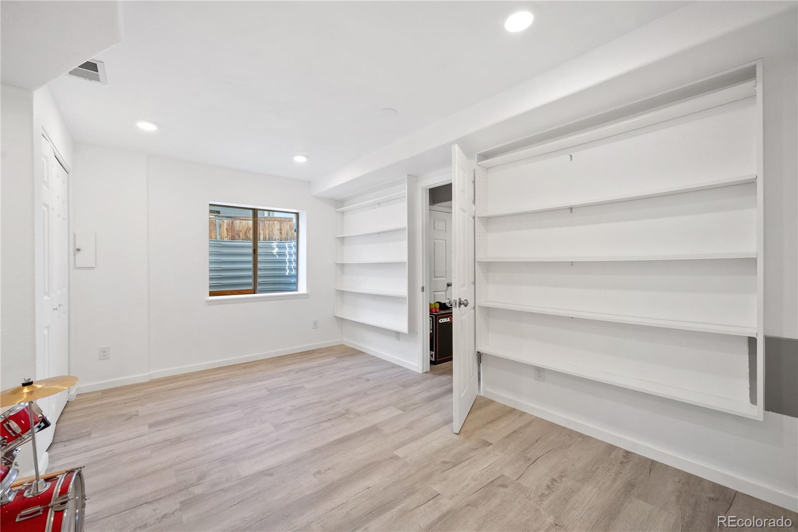 1201 Riddlewood Road Highlands Ranch, CO 80129 - Photo 33 of 36 a view of an empty room with a window and wooden floor
