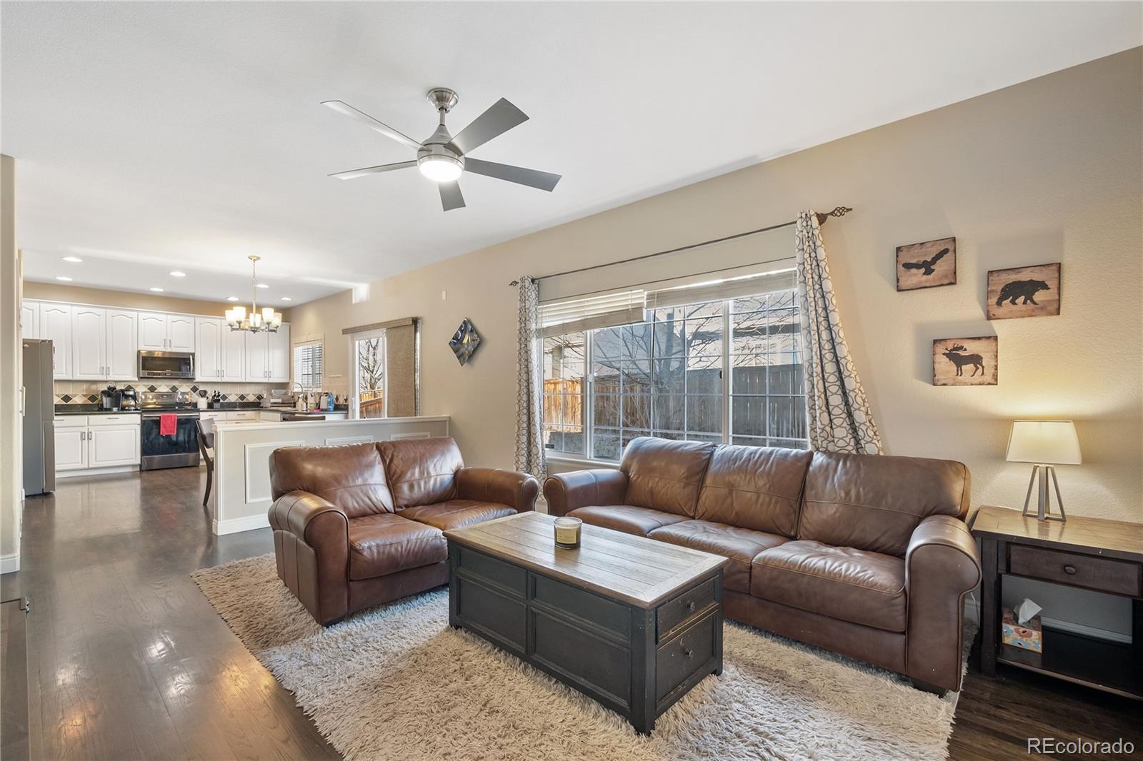 1201 Riddlewood Road Highlands Ranch, CO 80129 - Photo 6 of 36 a living room with furniture and kitchen view