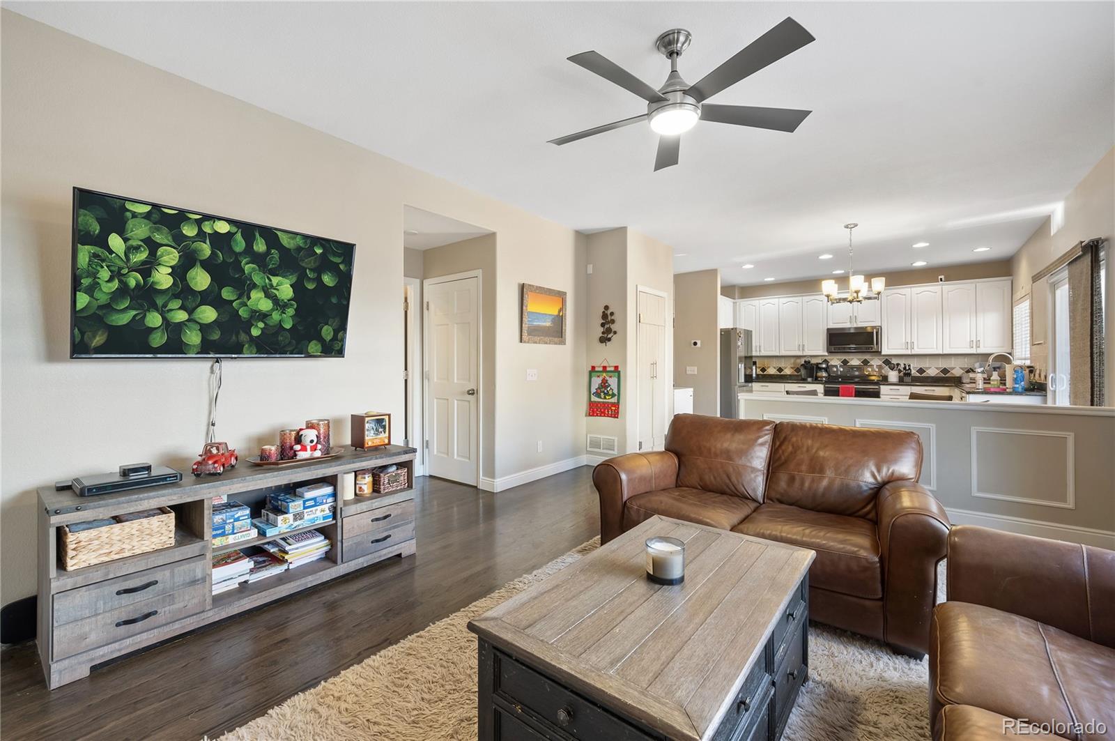 1201 Riddlewood Road Highlands Ranch, CO 80129 - Photo 7 of 36 a living room with furniture and a flat screen tv