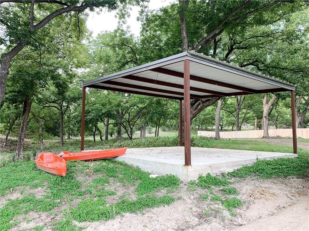 Lot 138 High Point Drive Kempner, TX 76539 - Photo 11 of 17 a backyard view with a table and chairs under an umbrella