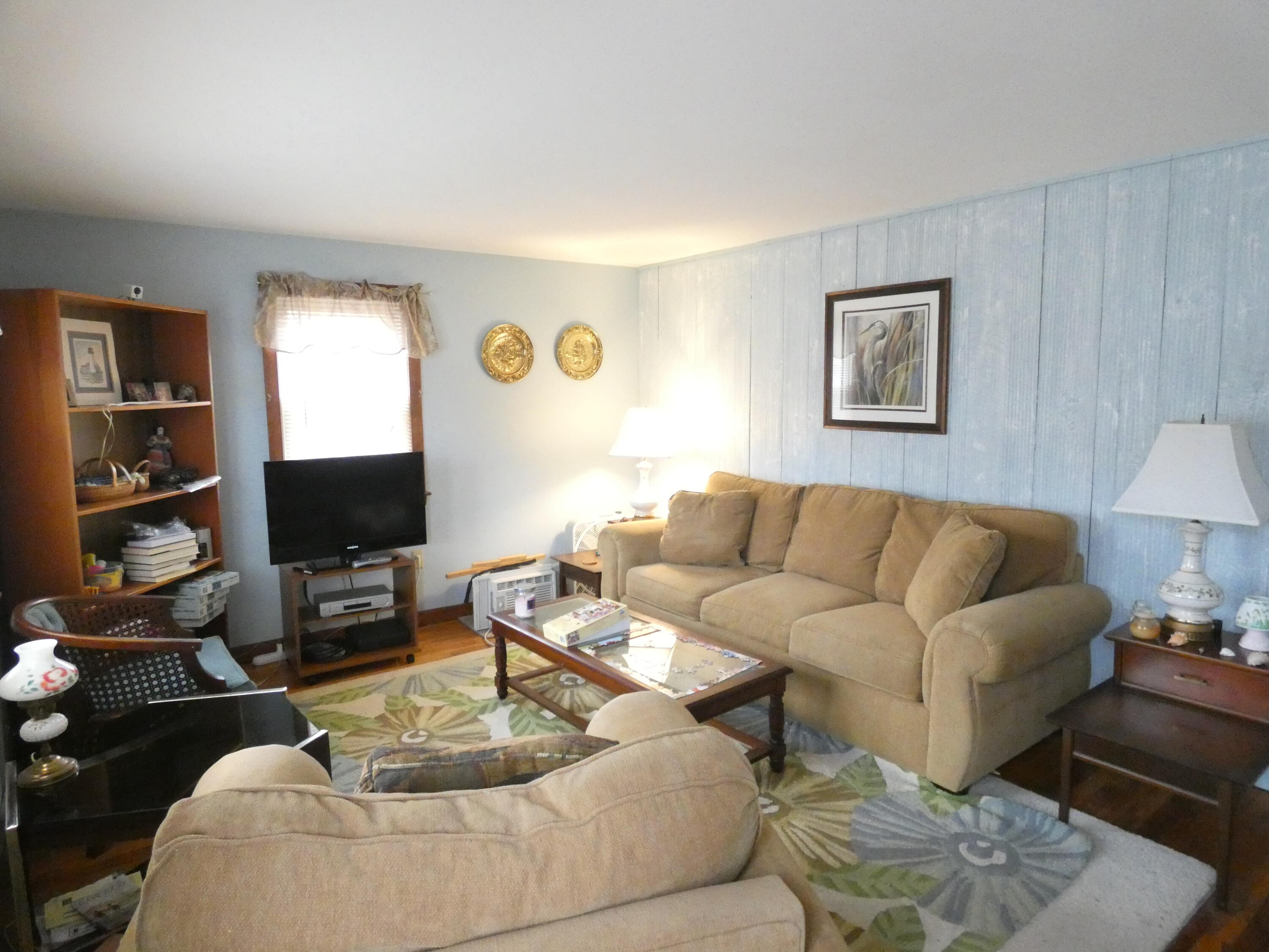 188 Swan River Road West Dennis, MA 02670 - Photo 21 of 39 a living room with furniture a lamp and a window