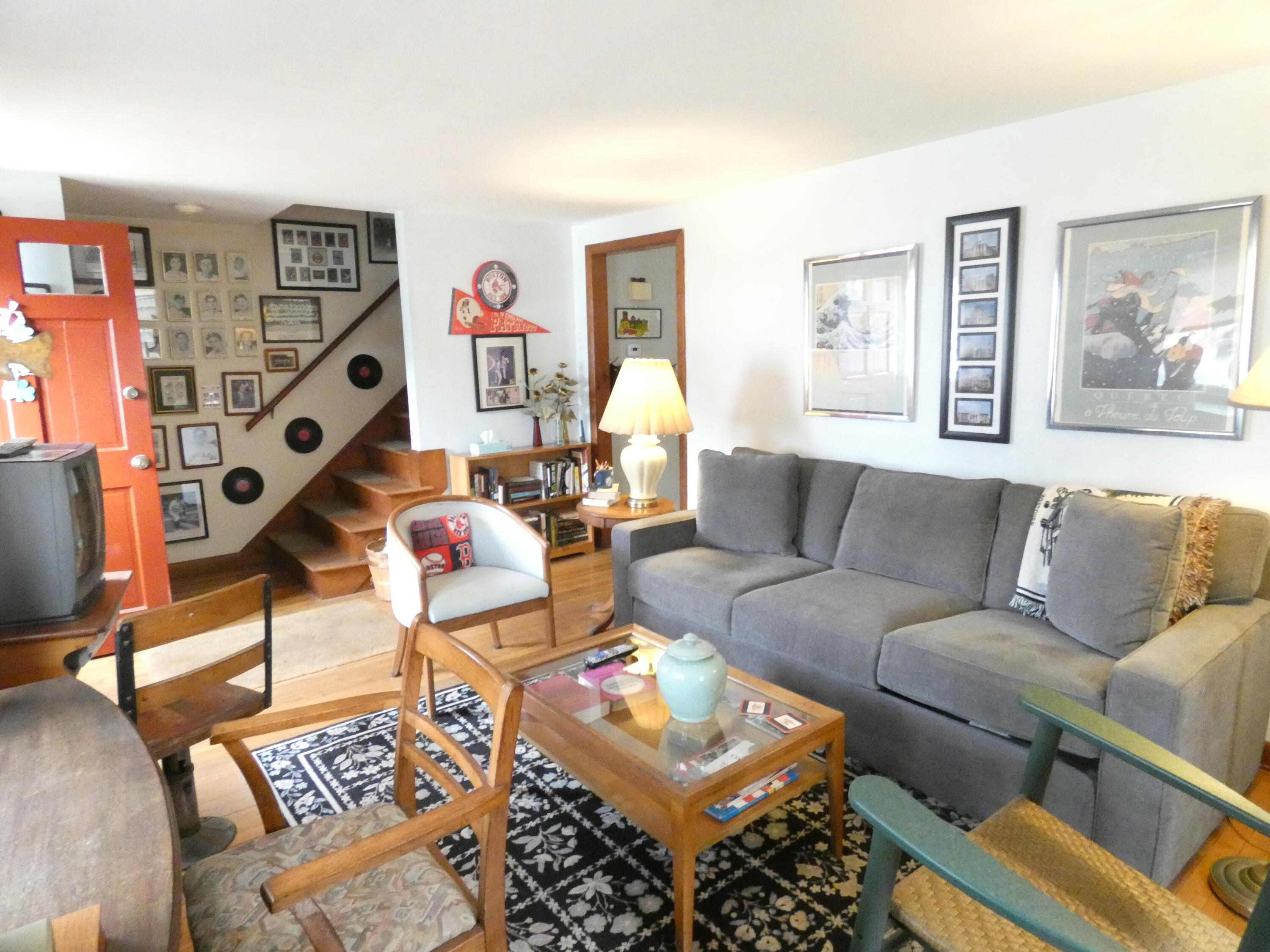 188 Swan River Road West Dennis, MA 02670 - Photo 5 of 39 a living room with furniture and a wall painting