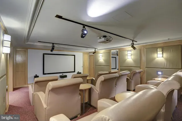 a media room with lots of chairs and a projector screen
