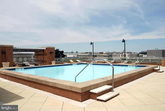 a roof deck with a table and chairs