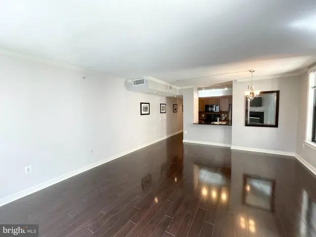 a view of a living room with kitchen