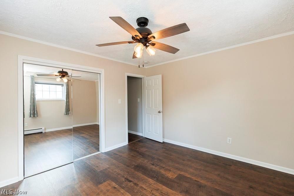 32618 Detroit Road Avon, OH 44011 - Photo 29 of 40 Wood-finish flooring, mirrored closet doors, ceiling fan with integrated lighting, and neutral wall tones