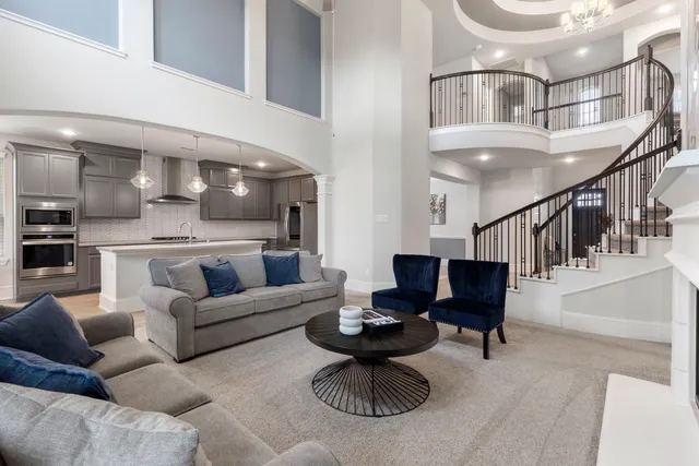 a living room with furniture kitchen view and a potted plant
