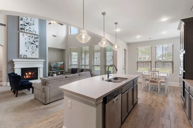 a large kitchen with a table and chairs
