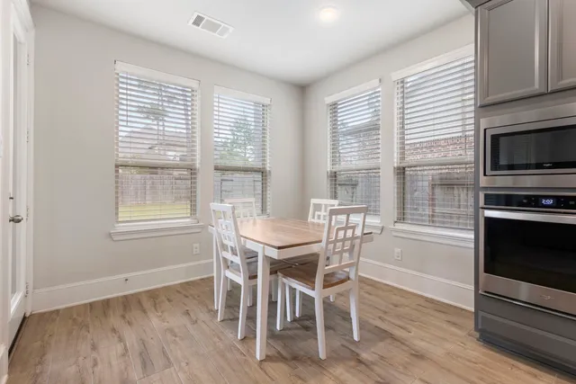 a view of a dining room with furniture window and wooden floor