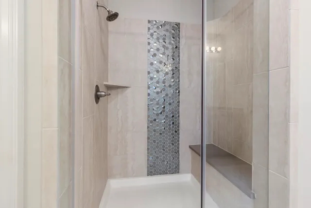 a bathroom with a shower and a tub