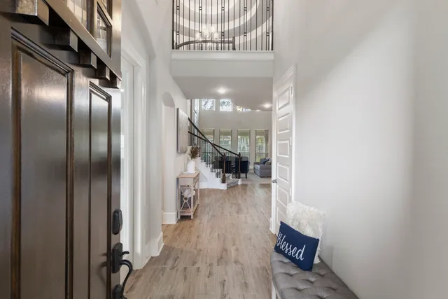 a view of entryway and hall with wooden floor