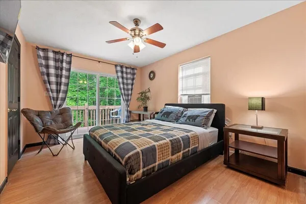 a bedroom with a large bed a chandelier and a window