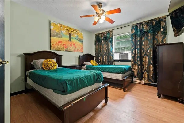 a bedroom with a bed and a window