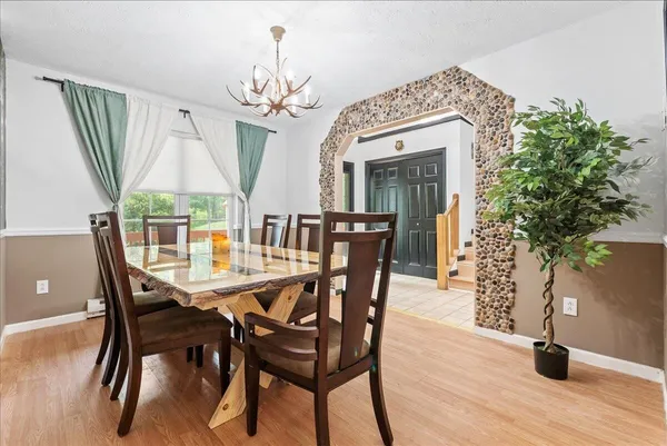 a view of a dining room with furniture window and wooden floor