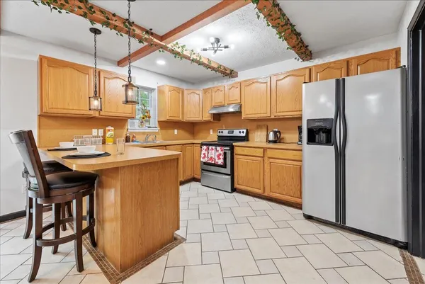 a kitchen with cabinets a sink appliances and a counter