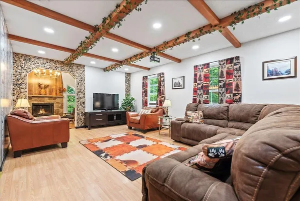 a living room with furniture a flat screen tv and a fireplace