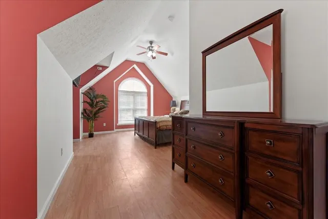 a bedroom with a bed and a potted plant