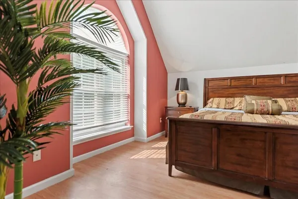 a balcony with wooden floor table and chairs