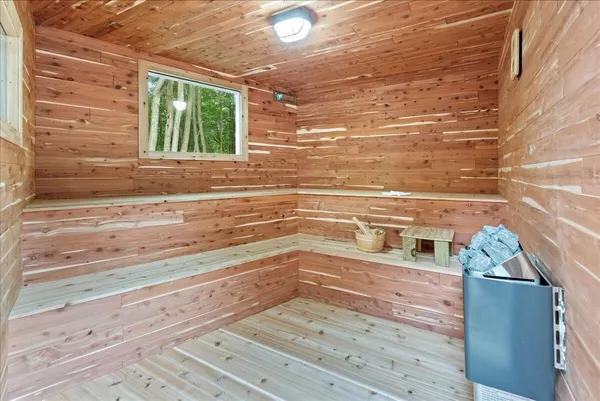 a view of a closet area with wooden floor
