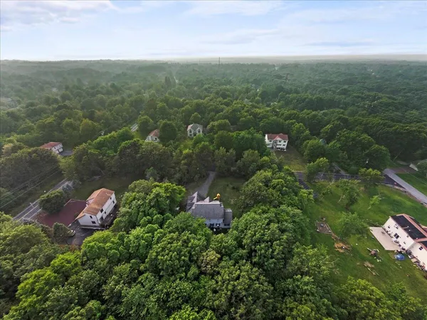 an aerial view of a house with a yard