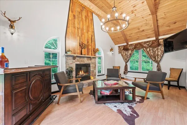 a living room with furniture a fireplace and a large window
