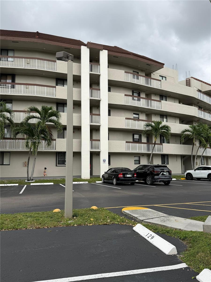 10288 Northwest 9th St Circle, Unit 307 Miami, FL 33172 - Photo 1 of 14 a view of a street with cars