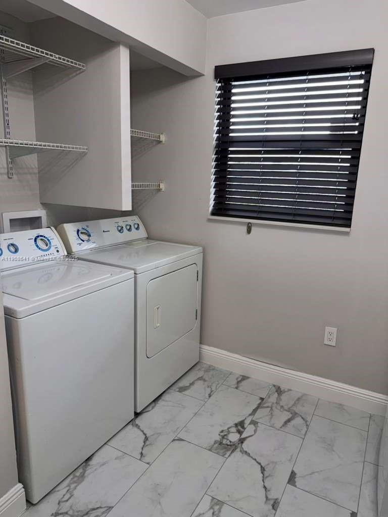 10288 Northwest 9th St Circle, Unit 307 Miami, FL 33172 - Photo 11 of 14 a utility room with dryer and washer