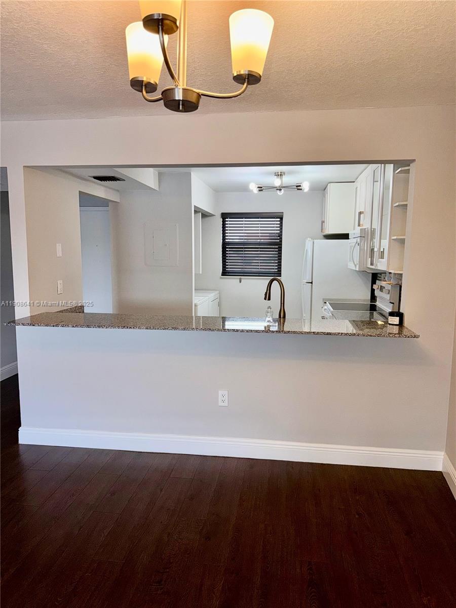 10288 Northwest 9th St Circle, Unit 307 Miami, FL 33172 - Photo 14 of 14 a kitchen with a sink and wooden floor