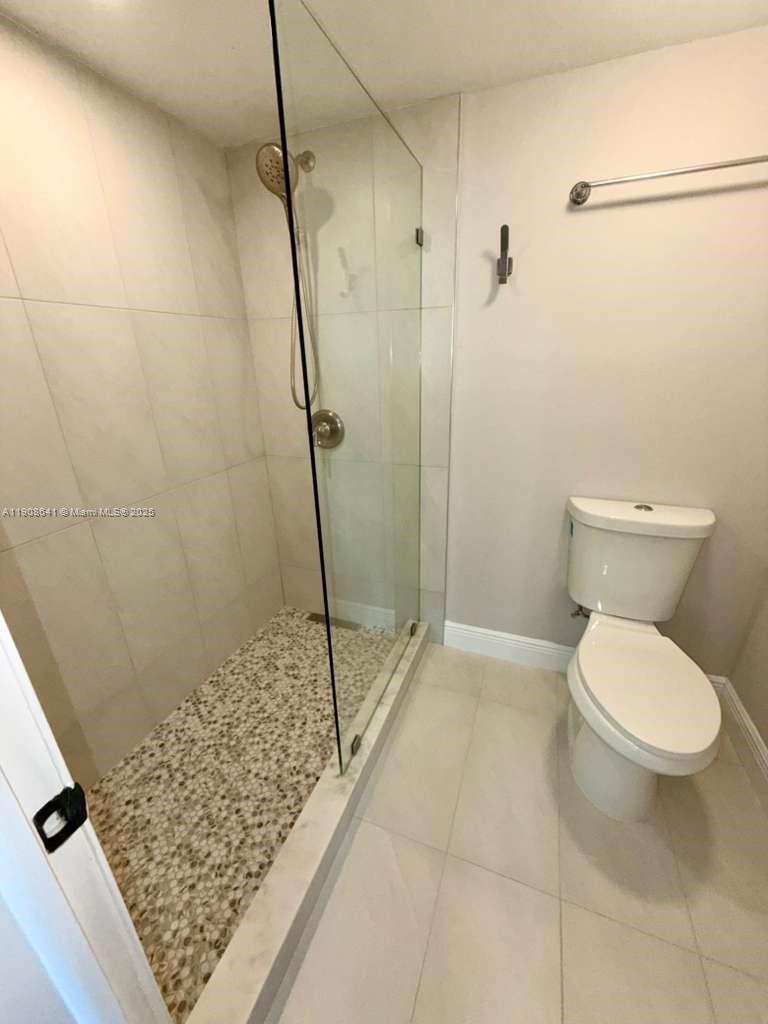 10288 Northwest 9th St Circle, Unit 307 Miami, FL 33172 - Photo 7 of 14 a bathroom with a toilet and a shower