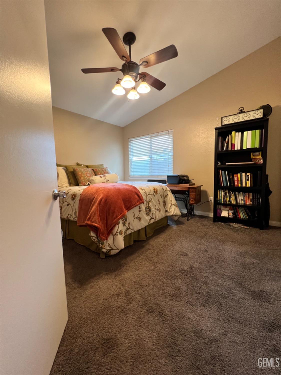 Undisclosed Address Bakersfield, CA 93307 - Photo 13 of 19 a bed room with a bed and a ceiling fan