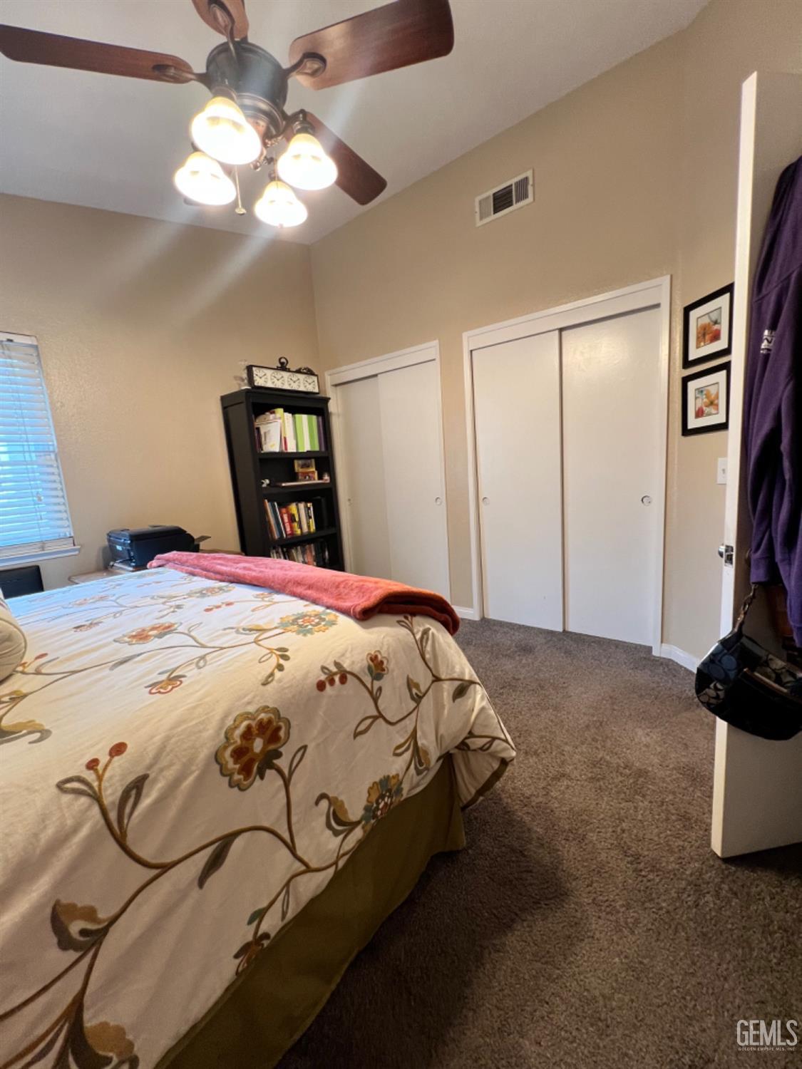 Undisclosed Address Bakersfield, CA 93307 - Photo 14 of 19 a bedroom with a bed and a chandelier