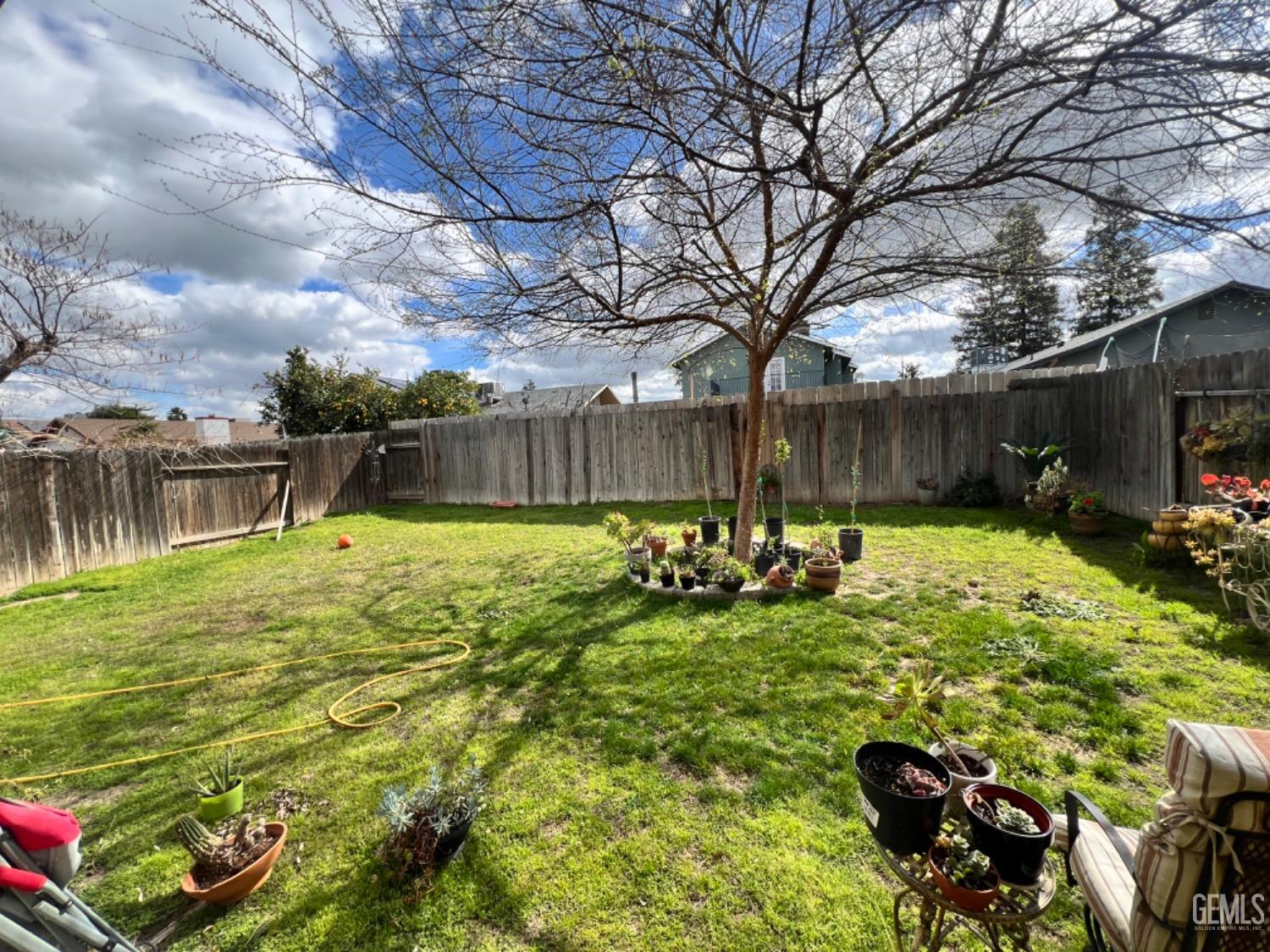 Undisclosed Address Bakersfield, CA 93307 - Photo 19 of 19 a view of a backyard with plants and a patio