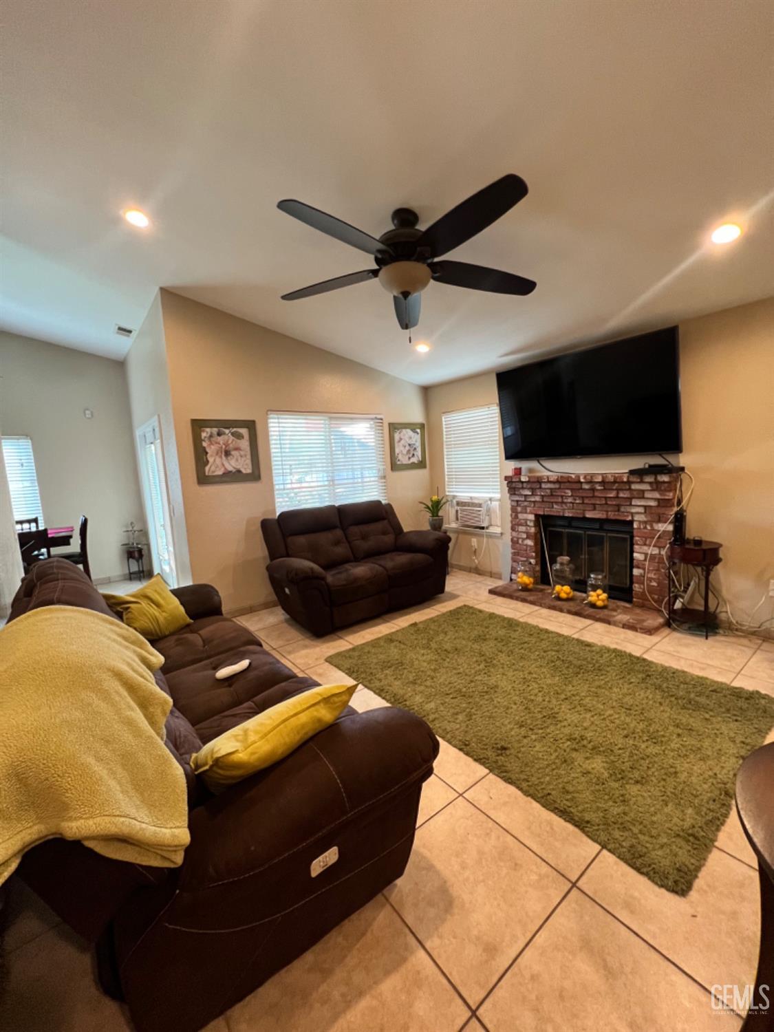 Undisclosed Address Bakersfield, CA 93307 - Photo 8 of 19 a living room with furniture and a fireplace