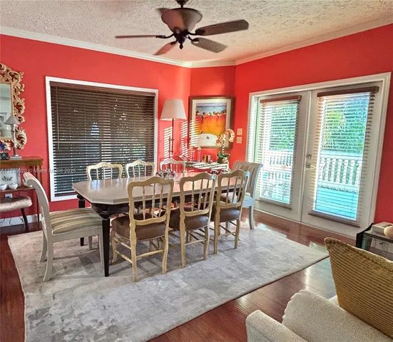 a dining room with furniture window and wooden floor