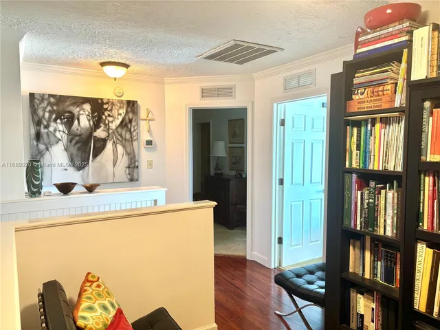 a bedroom with furniture and a flat screen tv