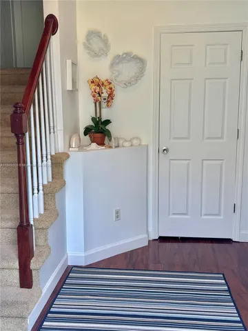 a view of a room with wooden floor and stairs