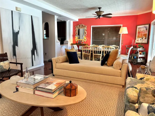 a living room with furniture and a chandelier