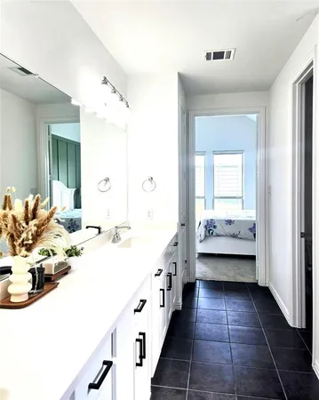 a bathroom with a double vanity sink and mirror