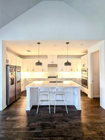 a kitchen with a table and chairs