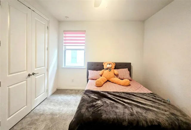 a bedroom with a bed and window