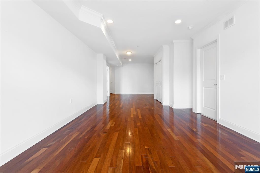 54 Polifly Road, Unit 311 Hackensack, NJ 07601 - Photo 11 of 20 a view of a room with wooden floor and bench