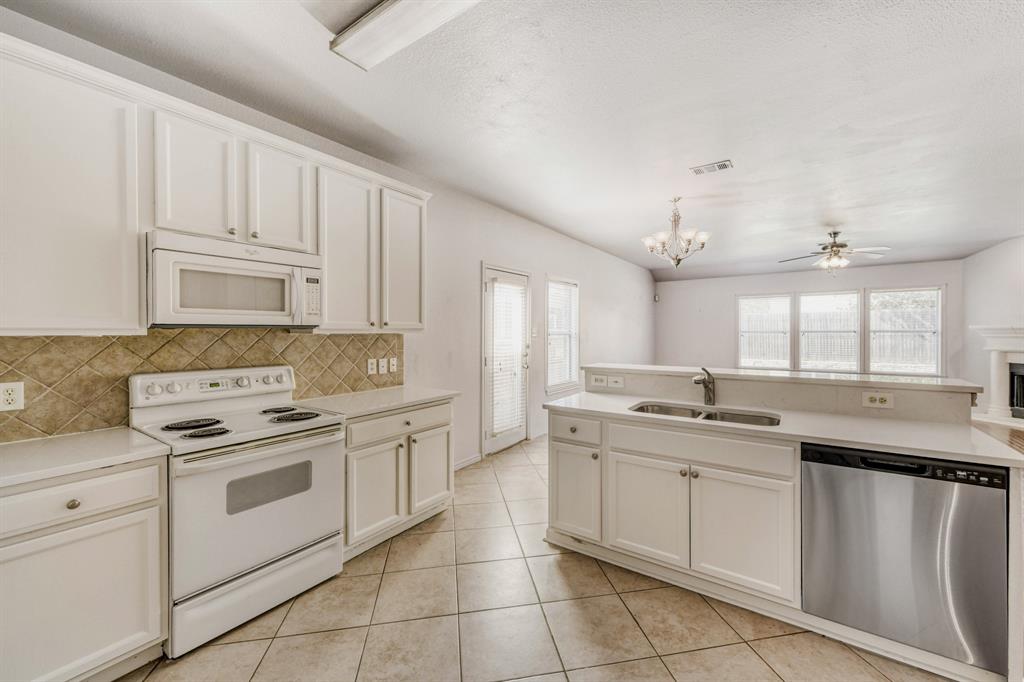 2617 Hereford Road Denton, TX 76210 - Photo 9 of 27 a kitchen with a sink stove and cabinets