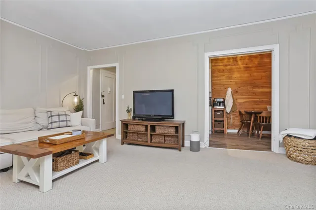 a bedroom with furniture and a flat screen tv