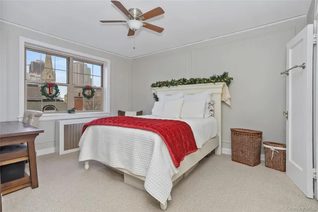a spacious bedroom with a bed and a cabinets