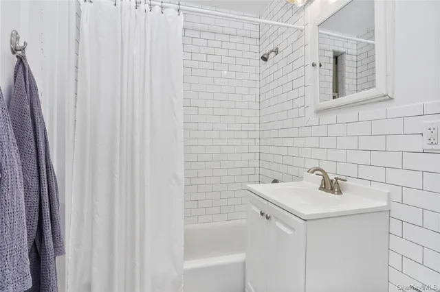 a bathroom with a sink a shower and a bathtub