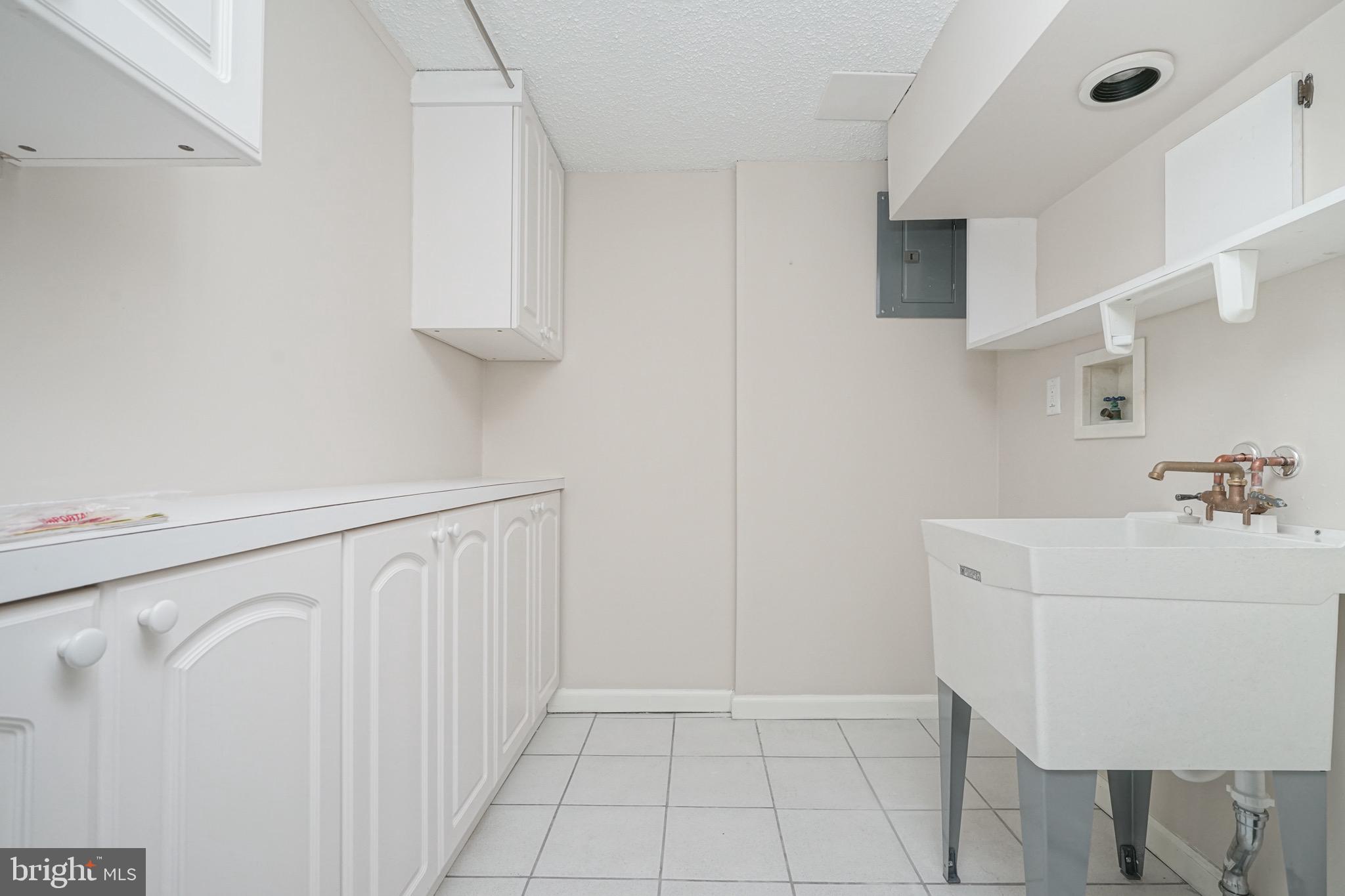 676 Renz Street Philadelphia, PA 19128 - Photo 31 of 36 Laundry Room with cabinetry and wash tub