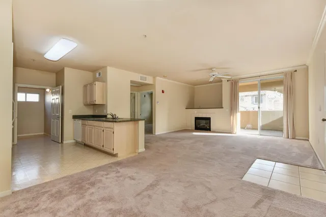 a view of kitchen with refrigerator and cabinets